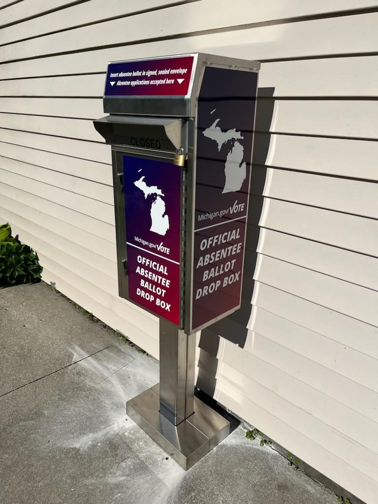 Official absentee ballot drop box on sidewalk.